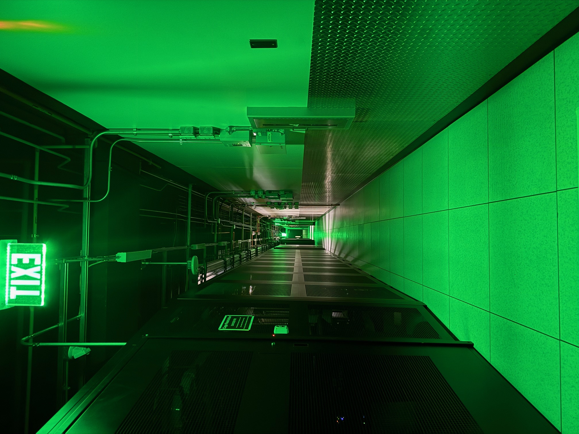 Data center corridor with green emergency lighting at the Dallas facility