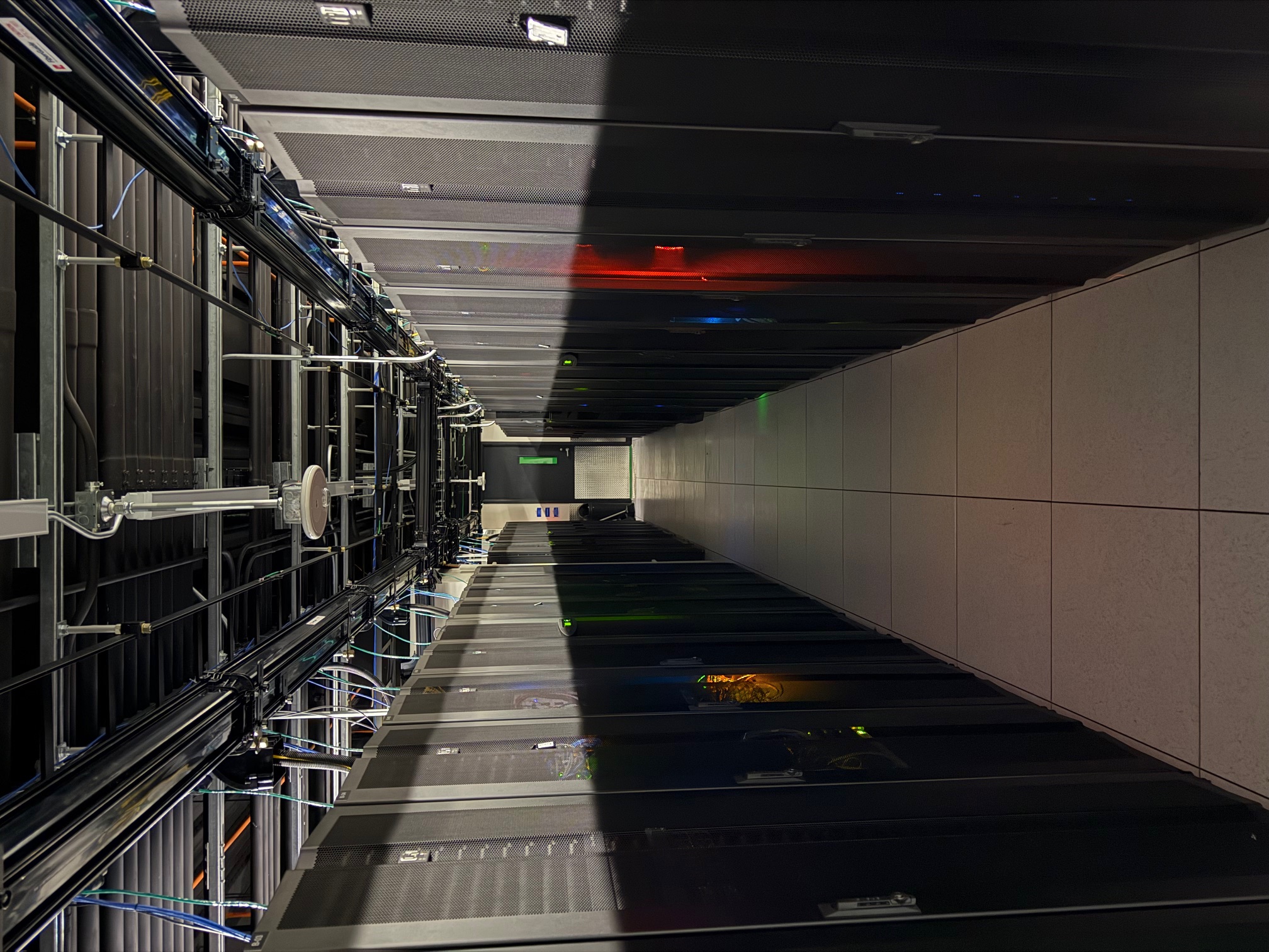 Server racks with colorful status lights in the Dallas data center cold aisle